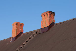 two masonry chimneys side by side
