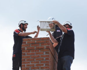 two techs working on chimney